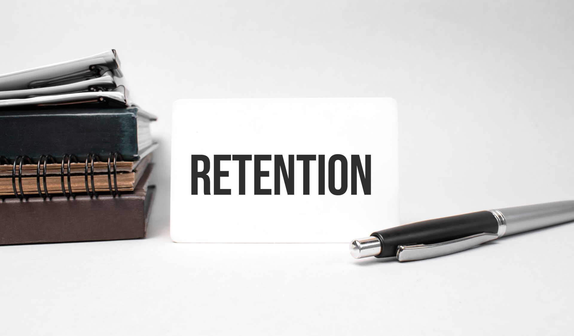 Paper plate, glasses, notepad in stack,pen and text retention on business card Paper plate, glasses, notepad in stack,pen and text retention on business card