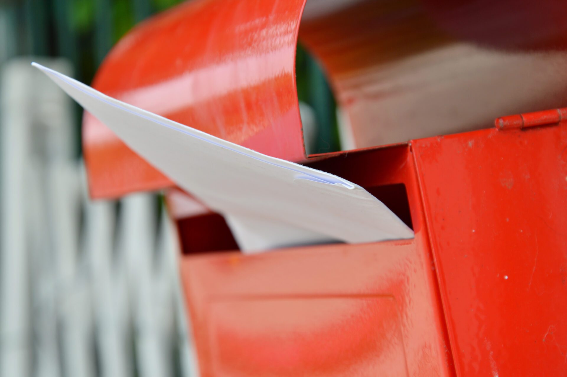letter in red mail box on home fence letter in red mail box on home fence
